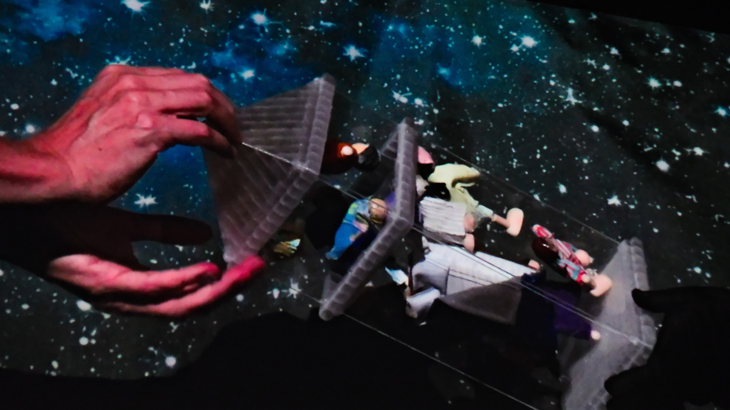 Hand reaching the glass pyramid